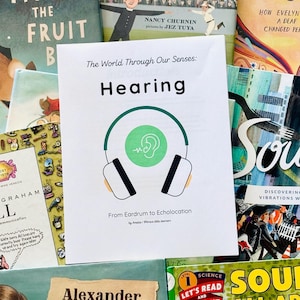 May include: A collection of children's books with colorful covers, including titles like "Fiona the Fruit Bat," "The William Hoy Story," and "Listen." A central card reads "Hearing" with a headphone graphic. Educational and science-themed.