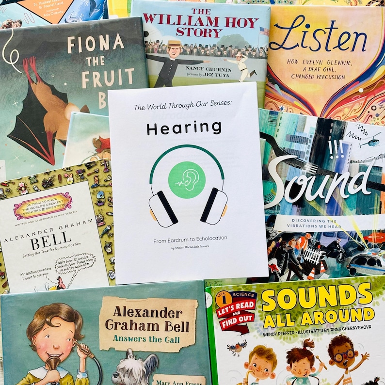 May include: A collection of children's books with colorful covers. Titles include "Fiona the Fruit Bat", "The William Hoy Story", "Listen", and "Sounds All Around". A central card reads "Hearing" with a headphone graphic.