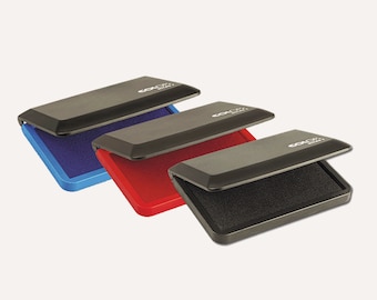 May include: Three ink pads with black plastic cases and different colored ink pads. The ink pads are blue, red, and black.