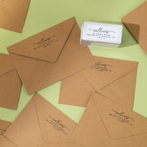 Using our self inking stamp to add return address on our envelopes.