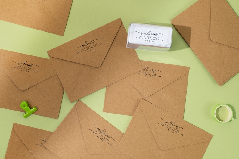 Using our self inking stamp to add return address on our envelopes.