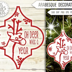 May include: Red and white Christmas ornament shaped like a quatrefoil with a reindeer wearing a face mask and the text "Oh Deer What a Year".