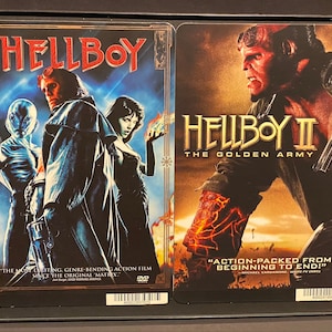 May include: Two DVD cases for the movies "Hellboy" and "Hellboy II: The Golden Army". The covers feature the main character, Hellboy, in a red demon form. The first case has a blue background with a quote that reads "The most exciting, genre-bending action film since the original Matrix". The second case has a brown background with a quote that reads "Action-packed from beginning to end!"