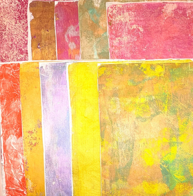 May include: A collection of colorful, textured paper sheets. The palette includes shades of red, orange, yellow, purple, and green. The papers have a variety of patterns and textures, with some appearing crinkled or layered. The overall effect is artistic and vibrant.