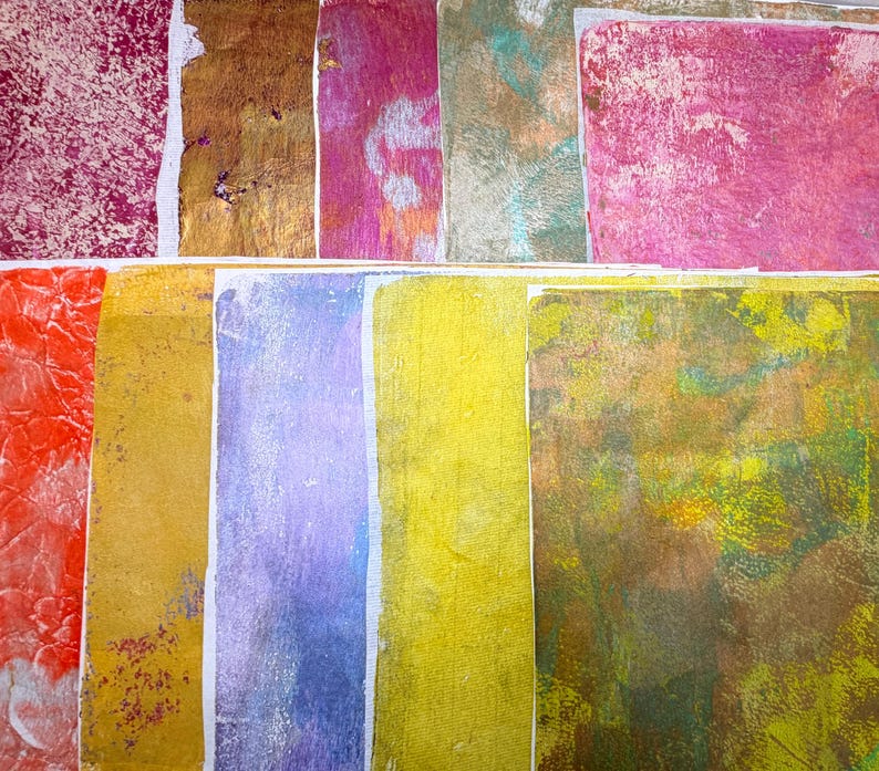 May include: An assortment of colorful, textured paper sheets. The papers display a variety of colors, including red, gold, purple, and yellow, with unique patterns and textures. Some sheets have a mottled appearance, while others have a more uniform color.