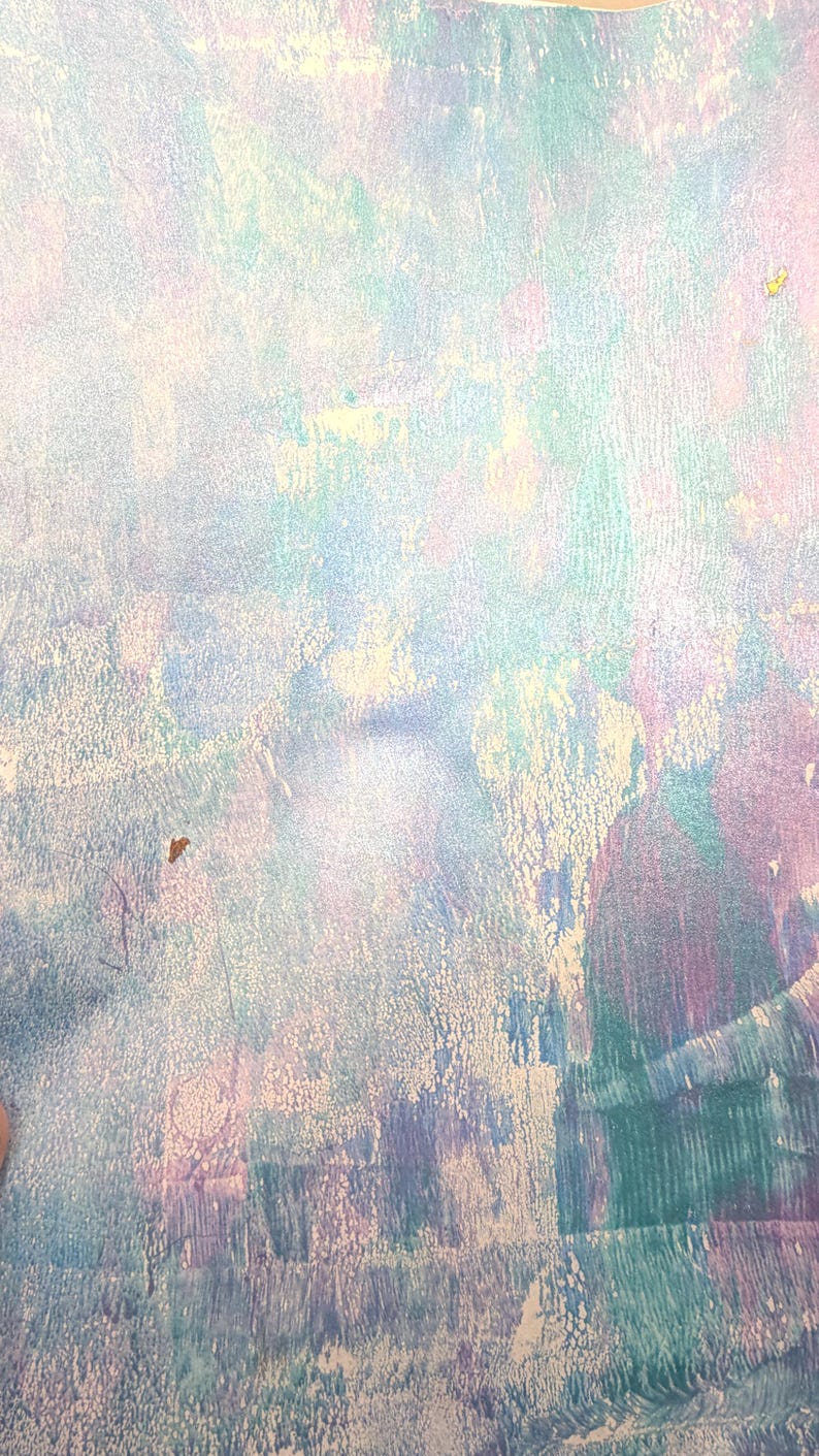 May include: Abstract artwork with a textured surface. The color palette includes shades of blue, purple, green, and white, creating a soft, ethereal effect. The piece has a layered appearance, with visible brushstrokes and a subtle, iridescent sheen.