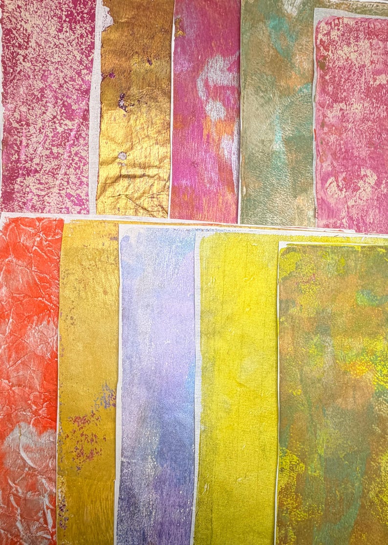 May include: An assortment of colorful, textured paper rectangles. The colors include shades of pink, gold, orange, green, yellow, and purple. The paper has a variety of textures, including crinkled and metallic finishes. The rectangles are arranged in a grid-like pattern.
