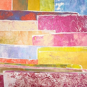 May include: Abstract artwork featuring layered rectangular shapes in various colors. The color palette includes shades of red, pink, yellow, blue, and green. The textures appear rough and textured, creating a visually dynamic composition.
