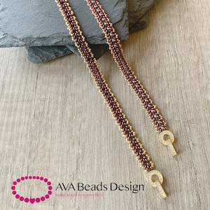 May include: Two beaded bracelets with gold and maroon beads. The bracelets have a gold clasp with clear rhinestones.