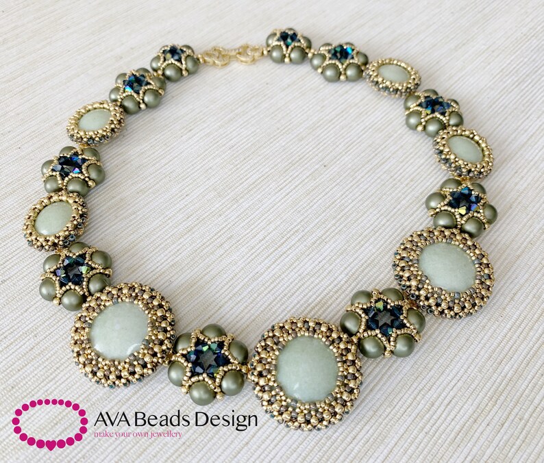 May include: A green and gold beaded necklace with round, light green stones and dark blue crystals. The necklace is made with seed beads and features a repeating pattern of flowers and circles. The necklace is on a white background.
