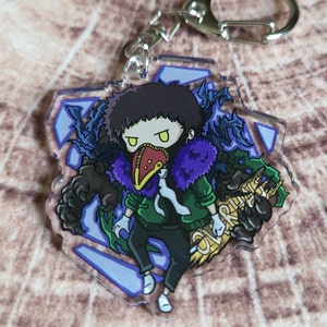 May include: A purple and green anime character keychain with a bird mask and a sign that says "Overhaul". The character is standing on a blue and white background.