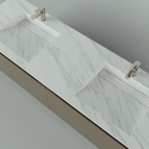 May include: A modern bathroom vanity with two integrated sinks and chrome faucets. The countertop features a white marble pattern, and the cabinet has a neutral, light brown finish. The design is sleek and minimalist, suitable for contemporary bathrooms.