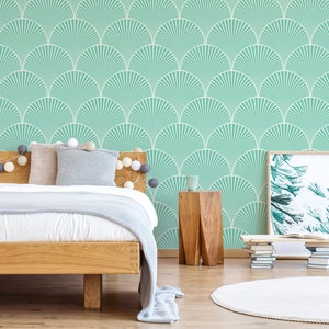May include: A bedroom with a bed, a side table, and a framed print. The walls are covered in a teal and white geometric wallpaper with a fan-like pattern.