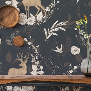 May include: A dark teal wallpaper with a repeating pattern of deer, flowers, and foliage in shades of beige and white. Wooden decorative items and a vase with flowers sit on a wooden shelf. The overall theme is nature and rustic decor.
