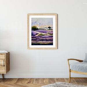 May include: A watercolor painting of a lavender field with a winding path leading to a small tree in the distance. The sky is a soft blue with white clouds.