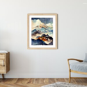 May include: A watercolor painting of a mountain range with a cloudy sky. The mountains are painted in shades of blue, brown, and orange. The sky is a light blue with white clouds.