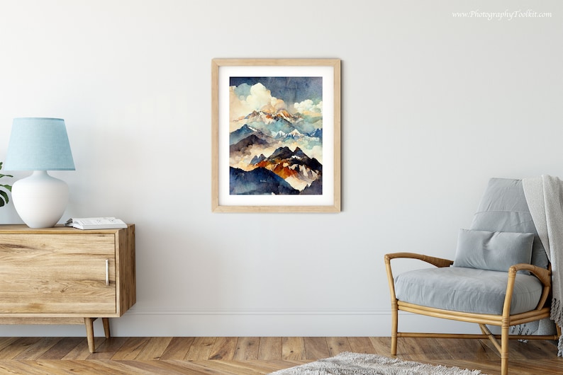 May include: A watercolor painting of a mountain range with a cloudy sky. The mountains are painted in shades of blue, brown, and orange. The sky is a light blue with white clouds.