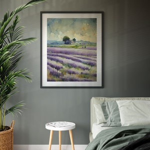 May include: A framed watercolor painting of a lavender field with a small cluster of trees in the distance. The painting is hanging on a gray wall above a white side table and a green bed.