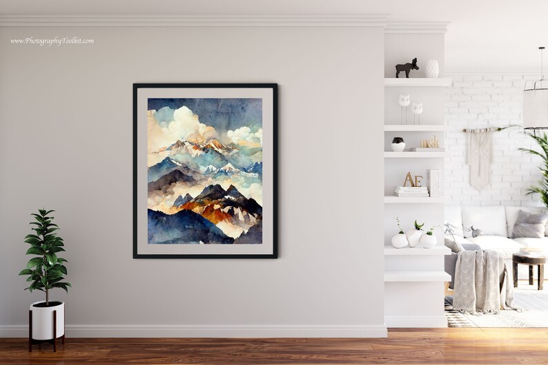 May include: A framed watercolor painting of a mountain range with a cloudy sky. The mountains are painted in shades of blue, green, and brown. The sky is a light blue with white clouds.