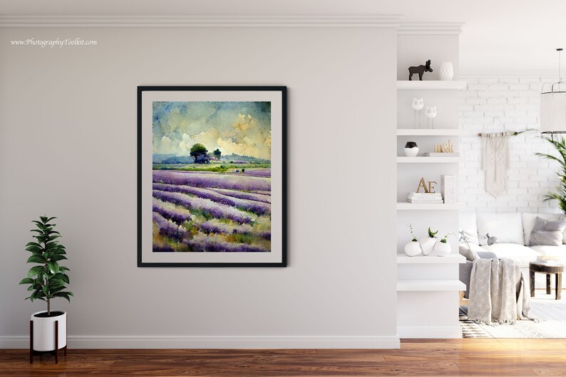 May include: A watercolor painting of a lavender field with a small house and trees in the distance. The sky is a light blue with white clouds. The painting is framed in black.