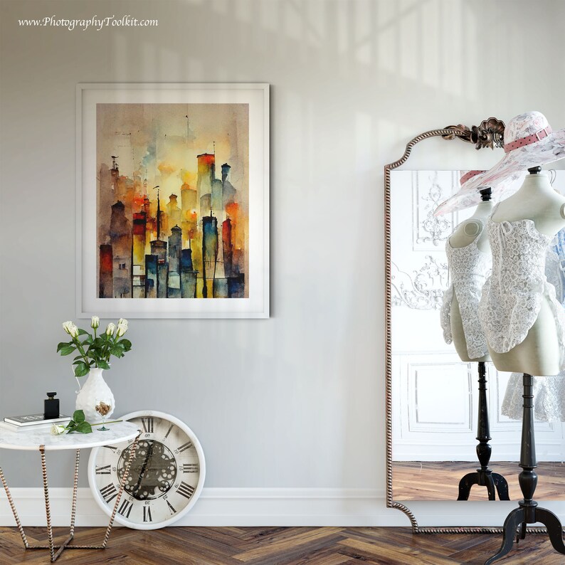 May include: A framed watercolor painting of a city skyline in shades of yellow, orange, blue, and green. The painting is hanging on a white wall next to a full-length mirror with a decorative frame.