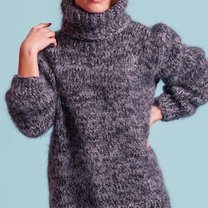 May include: A gray, fuzzy turtleneck sweater with a loose fit and long sleeves.