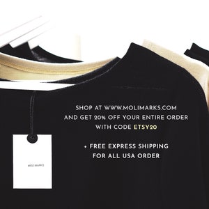 May include: A black t-shirt with a white tag that says "MOLI MARKS". The text on the t-shirt says "SHOP AT WWW.MOLIMARKS.COM AND GET 20% OFF YOUR ENTIRE ORDER WITH CODE ETSY20 + FREE EXPRESS SHIPPING FOR ALL USA ORDER".
