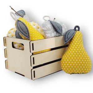 May include: A wooden crate filled with yellow and gray fabric pears. The pears have a star pattern and are decorated with gray felt leaves.
