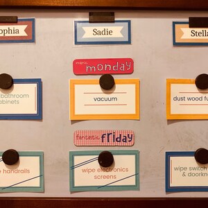 Chore cards displayed on fridge with magnets.