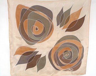 May include: A beige silk scarf with a brown, orange, and gray abstract floral design. The scarf has a white outline around the design.