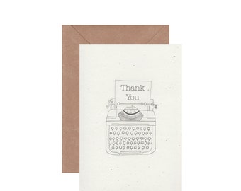 May include: A thank you card featuring a black and white illustration of a typewriter with the words "Thank You" typed on a sheet of paper.