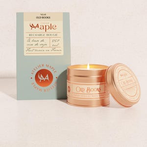 May include: A lit candle in a metallic copper tin labelled Old Books, accompanied by a rectangular sage green box. The box features the text Atelier Maple, No. 41 Old Books, and indicates a 250 ml volume. The candle lid rests beside the tin.