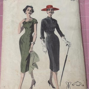 May include: Vintage Butterick sewing pattern featuring illustrations of two elegant dresses. The pattern cover displays the text "PRINTED PATTERNS" and details like "BUST 31 1/2" and "SIZE 11". The price is marked as 65¢. The dresses are in green and black.