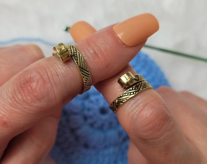 Edited gold colored crochet / knitting ring a yarn tension aid for crocheting and knitting. This is a left and right handed crochet / knitting ring