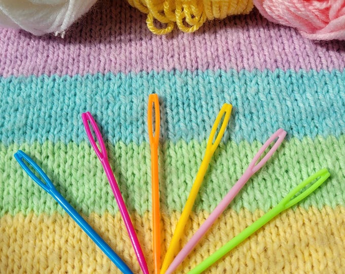 Set of 6 plastic sewing needles. Embroidery needles in cheerful colors. Sewing needles with a large eye.