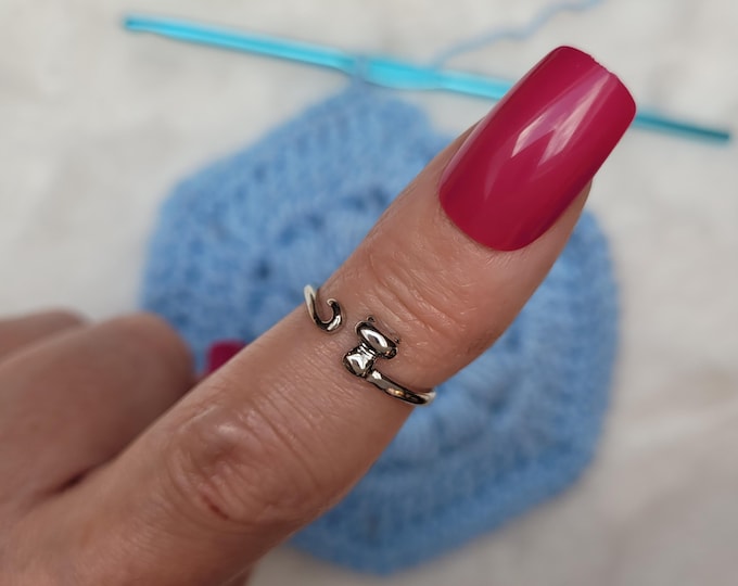 A cat hook or knit ring is a yarn tension aid for crocheting or knitting. This is a right-handed hook or knit ring.