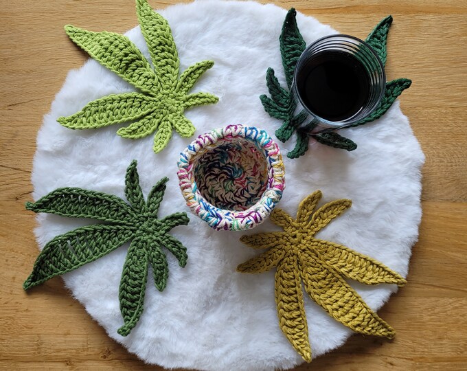 Crocheted coasters in the shape of cannabis leaves that fit in the jar