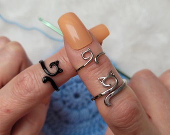 Cat crochet or knitting ring is a yarn tension aid for crocheting and knitting. Three different variations silver, gray/black and silver narrow