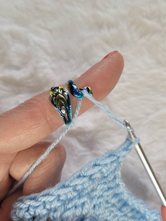 Colored Peacock crochet or knitting ring, a yarn tension aid for crocheting  and knitting