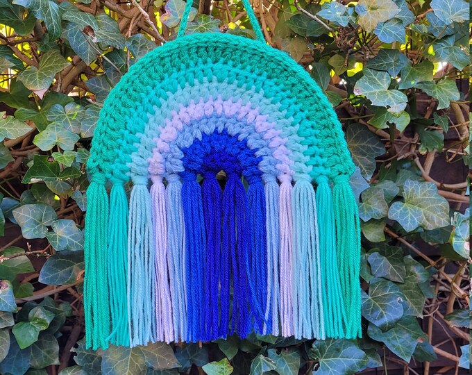 Crocheted rainbow pendant in the colours of the gay flag.