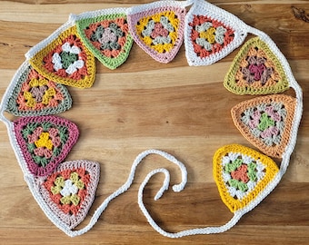 Crocheted garland with 10 granny square flags in autumn colours.