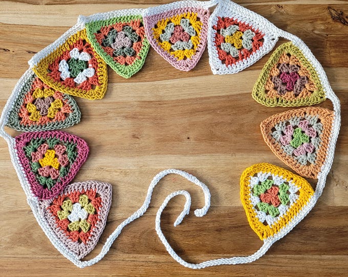 Crocheted garland with 10 granny square flags in autumn colours.