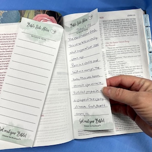 May include: Open Bible with two "Bible Side Notes" bookmarks. One bookmark has lines for notes, the other has handwritten notes about John 1:14. The text "Girl read your Bible!" is visible.