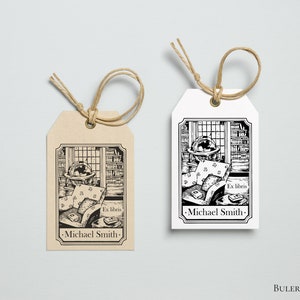 May include: Two brown and white gift tags with black and white illustrations of a globe, books, and a chair. The text on the tags reads "Ex libris -Michael Smith-"