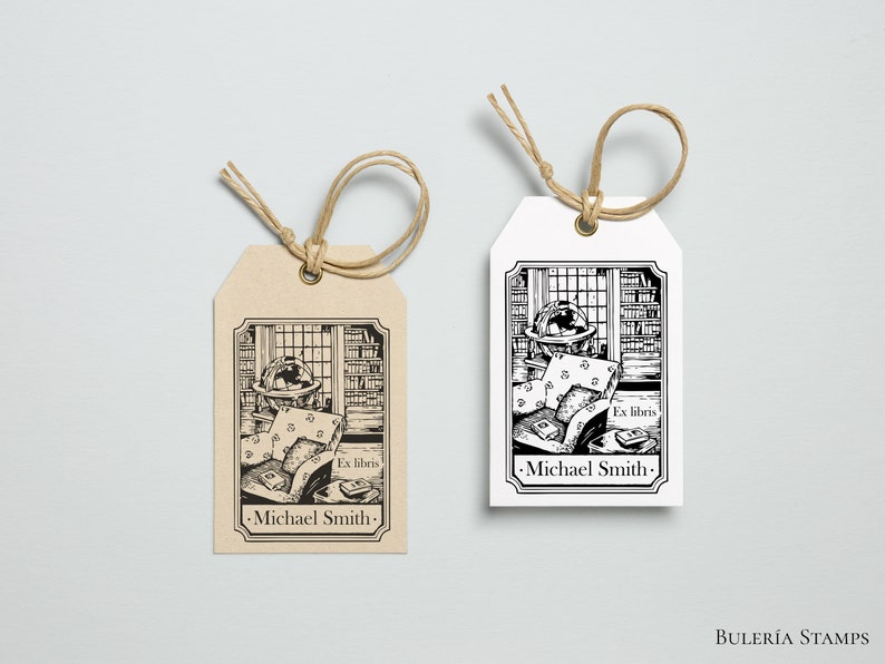 May include: Two brown and white gift tags with black and white illustrations of a globe, books, and a chair. The text on the tags reads "Ex libris -Michael Smith-"