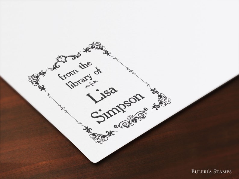 Puede incluir: Un sello en blanco y negro con un borde decorativo. El sello dice "from the library of Lisa Simpson".