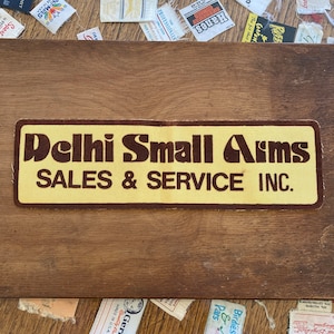 1970er Jahre delle puk beflockte Patch Vintage Retro Werbe Werbung Abzeichen Logo Unternehmen Sammlerstücke Memorabilie