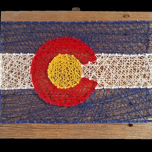 Handcrafted Colorado flag string-art made on reclaimed cedar planks