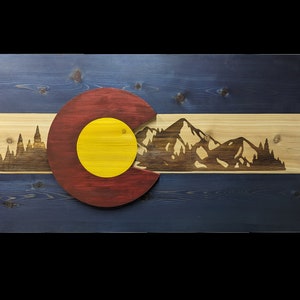 Handcrafted Wooden Colorado Flag cut with a scroll saw from cedar with laser engraved mountains