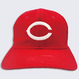 May include: A red baseball cap with a white "C" embroidered on the front.